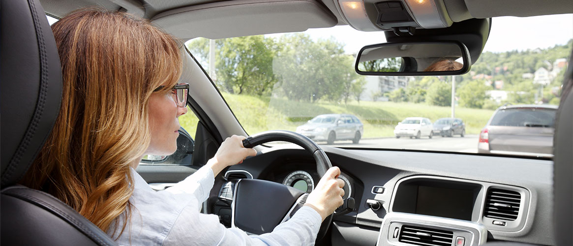 person driving with two hands on the wheel
