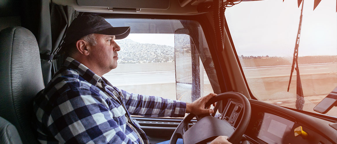 truck driver in cab of truck